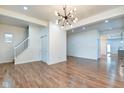 Open-concept living room featuring hardwood floors and staircase at 1229 N Keystone Ave, Indianapolis, IN 46201
