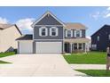 Beautiful two-story home with a three-car garage, well-manicured lawn, and a charming front porch at 1130 Cobra Dr, Franklin, IN 46131