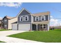 Charming two-story home with a three-car garage and inviting front porch at 1130 Cobra Dr, Franklin, IN 46131