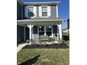 Charming home featuring a cozy front porch, white columns, shutters, and a well-manicured garden at 1130 Cobra Dr, Franklin, IN 46131