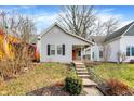 Gray house with orange door, black shutters, and a small porch at 1337 Linden St, Indianapolis, IN 46203