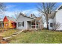 Gray house with orange door, black shutters, and a small porch at 1337 Linden St, Indianapolis, IN 46203