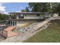 Lakefront home with stone retaining wall and patio at 7438 Haw Dr, Nineveh, IN 46164