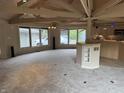 Expansive living room featuring large windows, vaulted ceilings, and easy access to the kitchen area at 4161 S Summit Ln, Columbus, IN 47201