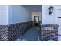 Inviting front entrance with brick accents, modern lighting fixture, and a well-defined address plaque at 4979 Elaine Ct, Noblesville, IN 46062