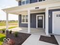 Inviting front entrance featuring a covered porch with white columns and a modern front door at 1537 Hanover St, Danville, IN 46122