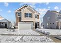Attractive two-story home with a two-car garage and well-kept lawn in a friendly neighborhood, featuring a snowy yard at 5143 Rolling Meadow Blvd, Indianapolis, IN 46237