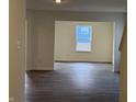 Bright living room with hardwood floors, large windows, and neutral wall color at 11015 Walter Dr, Indianapolis, IN 46235