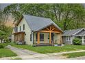 Craftsman style home with a custom wood porch, inviting curb appeal, and mature trees at 6129 Crittenden Ave, Indianapolis, IN 46220
