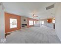 Open living room features a fireplace, neutral carpet, and plenty of natural light at 1162 Meadowlark Dr, Greenwood, IN 46143
