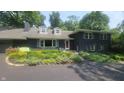 Classic two-story home boasts a well-maintained front yard with mature landscaping and inviting curb appeal at 6205 Bramshaw Rd, Indianapolis, IN 46220