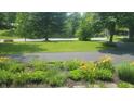 View of beautifully landscaped front yard at 6205 Bramshaw Rd, Indianapolis, IN 46220