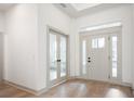 Bright entryway with light hardwood floors, neutral walls, and French doors at 15786 Vitalize Run, Fishers, IN 46040