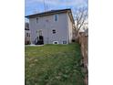 Spacious backyard featuring a well-maintained lawn, a small patio area, and a privacy fence at 2828 Robson St, Indianapolis, IN 46201