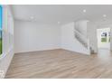 Spacious living room with hardwood floors and a staircase at 300 N Bur Oak Dr, Mooresville, IN 46158