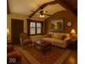 Cozy living room features paneled walls, a ceiling fan, stylish furniture, and warm lighting for a comfortable atmosphere at 610 E Morgan St, Martinsville, IN 46151