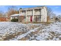 Two-story house with a red door and snow-covered lawn at 2103 Danbury Dr, Indianapolis, IN 46231