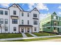 Charming new construction townhome with a white exterior, dark trim, and a well-manicured lawn at 4191 Barrel Ln, Westfield, IN 46062