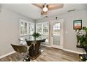 Cozy dining area featuring large windows and a stylish glass table at 7854 Harbour Isle, Indianapolis, IN 46240