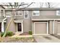 Charming townhome featuring a one-car garage, neat landscaping, and neutral toned siding at 7854 Harbour Isle, Indianapolis, IN 46240