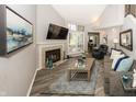 Bright living room with a fireplace, vaulted ceilings, and wood-look floors at 7854 Harbour Isle, Indianapolis, IN 46240