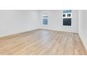 Spacious bedroom with light wood flooring and large windows at 9275 Loyola Way, Plainfield, IN 46168