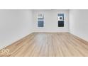 Bright and airy bedroom with wood-look flooring and neutral walls at 9275 Loyola Way, Plainfield, IN 46168