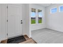 Bright entryway with white door and view to backyard at 9275 Loyola Way, Plainfield, IN 46168