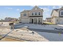 Attractive two-story home featuring a covered entry, and neatly kept snow-covered lawn at 10133 Redwood Peak Ln, Indianapolis, IN 46259