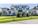 Elegant two-story home with a stone and white brick exterior and a meticulously maintained front lawn at 10937 Pete Dye Rdg, Zionsville, IN 46077