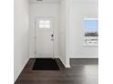 Bright foyer featuring hardwood floors, white walls, and a window for natural light at 7856 Magnolia St, New Palestine, IN 46163