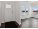 Bright entryway featuring hardwood floors, white walls, and natural light at 7856 Magnolia St, New Palestine, IN 46163