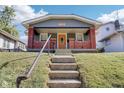 Gray house with brick front porch and steps, a welcoming entrance at 2161 Napoleon St, Indianapolis, IN 46203