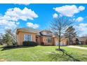 Charming brick home featuring a spacious lawn and three-car garage at 3719 Carwinion Way, Carmel, IN 46032