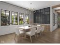 Elegant dining room with contemporary lighting, a wall of windows, and a stylish table setting at 1717 Beaufain St, Carmel, IN 46032