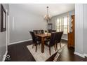 Formal dining room features hardwood floors and chandelier at 3584 Inverness Blvd, Carmel, IN 46032