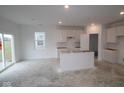 Bright kitchen featuring new white cabinets and sliding glass doors to the yard at 5057 Modernist Blvd, Indianapolis, IN 46237