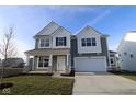 Two-story home with gray siding, white accents, and a stone facade at 16799 Cheddar Dr, Noblesville, IN 46060