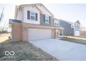 Charming two-story home with attached two car garage and long concrete driveway at 6123 Card Blvd, Indianapolis, IN 46221