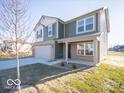 Charming two-story home with attached two car garage with green and white siding at 6123 Card Blvd, Indianapolis, IN 46221