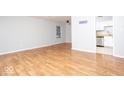Open-concept living room with beautiful wood floors and a view of the kitchen at 6072 Wingedfoot Ct, Indianapolis, IN 46254