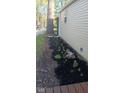 Landscaped flower bed featuring colorful flowers and dark mulch, adding curb appeal to the home's exterior at 184 Lake Hart, Mooresville, IN 46158