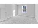 Spacious bedroom with grey carpeting and a window at 420 Charles Freer Ln, Whiteland, IN 46184