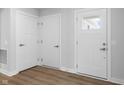 Bright entry hall with three white doors and wood-look flooring at 420 Charles Freer Ln, Whiteland, IN 46184