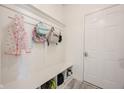 Practical mudroom with built-in bench, storage cubbies and white wood paneling at 5573 Mahogany Dr, Noblesville, IN 46062