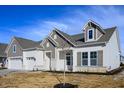 Charming home exterior with stone accents and a well-manicured lawn, showcasing inviting curb appeal at 15846 Vitalize Run, Fishers, IN 46040
