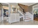 Foyer with marble flooring, decorative accents and an open staircase to the second floor at 6906 Johnson Rd, Indianapolis, IN 46220
