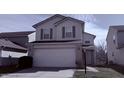 Two-story home featuring a large two car garage and light-colored siding at 5325 Bluff View Dr, Indianapolis, IN 46217
