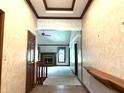 Hallway showcasing detailed trim work, leading to the living room with fireplace and abundant natural light at 1079 Old Eagle Way, Greenwood, IN 46143