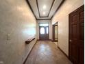 Spacious front hallway featuring detailed trim work, a shelf, and a front door at 1079 Old Eagle Way, Greenwood, IN 46143